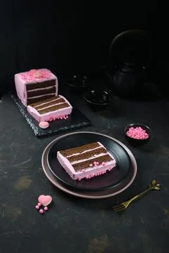 Chocolate layer cake covered with pink cream Fotos de archivo
