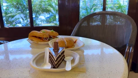 Chocolate Layer Cake with Fresh Sandwiches on a Restaurant Table Video stock 341908179