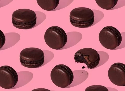 Chocolate macarons pattern on pink background isolated Stock Photos