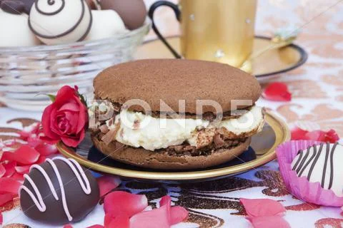 A chocolate macaroon filled with mascarpone cream Stock Photos
