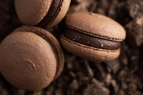 Chocolate macaroons on brown background macro Stock Photos