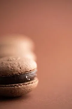 Chocolate macaroons on brown background macro Stock Photos