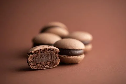 Chocolate macaroons on brown background macro Stock Photos