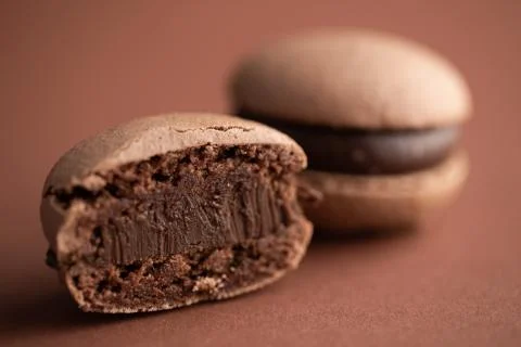 Chocolate macaroons on brown background macro Stock Photos