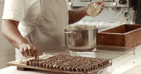 Chocolate master in his factory makes a truffles. Chocolate truffles making of Stock Footage