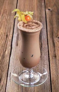Chocolate milkshake with cherry and mint garnish Stock Photos
