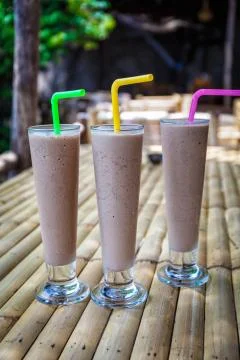 Chocolate milkshakes on bamboo table Fotos de archivo