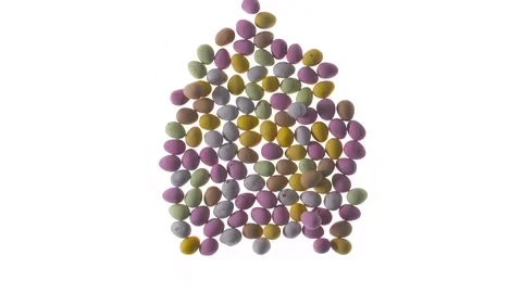 Chocolate mini eggs appear in the shape of a large egg Stock Footage 270801973