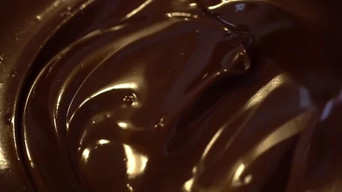 Chocolate. Mixing melted liquid premium dark chocolate. Close up of liquid hot Stock Footage 122665973