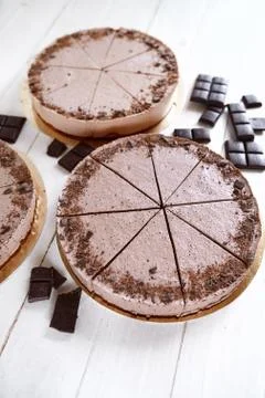 Chocolate mousse cheesecakes with a sprinkle of grated chocolate on a wooden Stock Photos