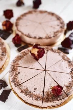 Chocolate mousse cheesecakes with a sprinkle of grated chocolate on a wooden Stock Photos