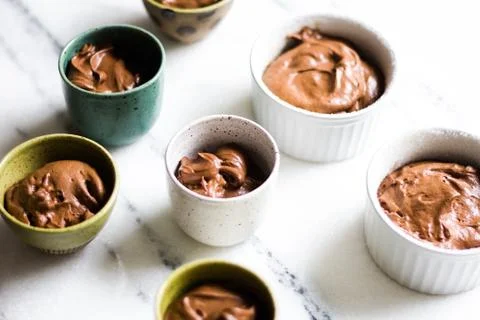 Chocolate mousse on tiny cups and marble background Stock Photos