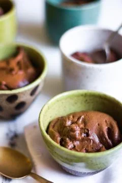 Chocolate mousse on tiny cups and marble background Stock Photos