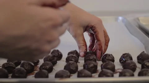 Chocolate mousse truffles being placed onto a cookie sheet 스톡 동영상 60717845
