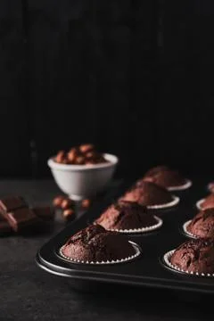 Chocolate muffins in bakeware Stock Photos