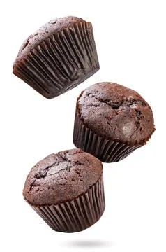 Chocolate muffins falling on white background. Isolated Stock Photos