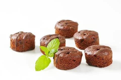 Chocolate muffins with mint leaf garnish Stock Photos