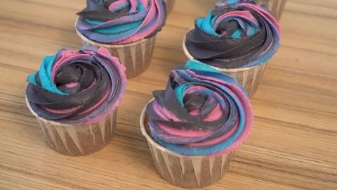Chocolate muffins with multi-colored cream. cupcakes dolly Stock Footage 86770678