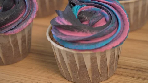Chocolate muffins with multi-colored cream. cupcakes dolly Stock Footage 86770944