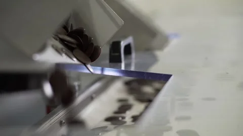 Chocolate mugs for cakes falling down to the conveyor close up Stock-Footage 130356802