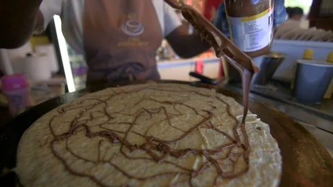 Chocolate nut spread being poured onto a crepe Stock Footage 84651203