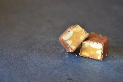 Chocolate with nuts on a black background Stock Photos