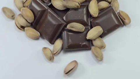 Chocolate, nuts, spices on a smooth white table Vidéo 81227783