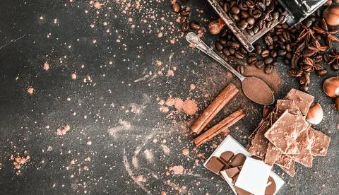Chocolate, nuts, spices on table Stock Photos