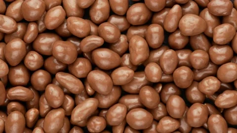 Chocolate nuts, top view. Glazed peanuts, dolly shot. Stock Footage 148975413