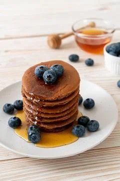 Chocolate pancake stack with blueberry and honey Stock Photos