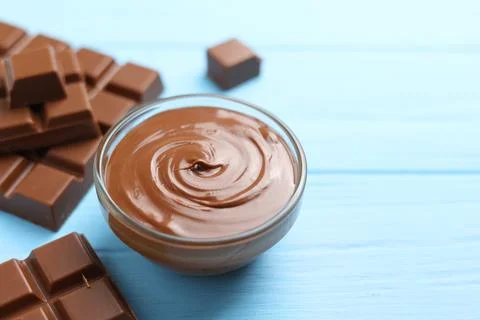 Chocolate paste with a bowl on a table. Stock Photos