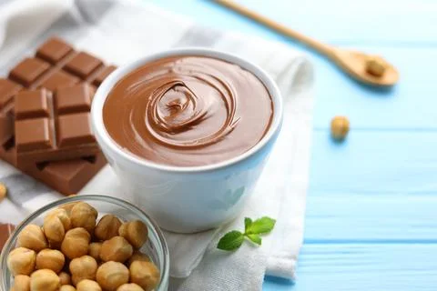 Chocolate paste with a bowl on a table. Stock Photos