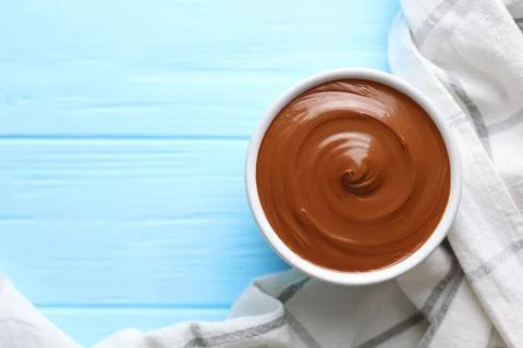 Chocolate paste with a bowl on a table. Stock Photos