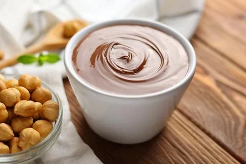 Chocolate paste with a bowl on a table. Stock Photos