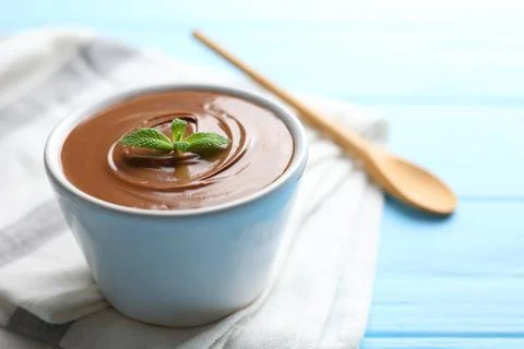 Chocolate paste with a bowl on a table. Stock Photos