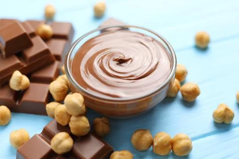 Chocolate paste with a bowl on a table. Stock Photos