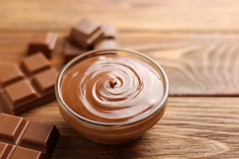 Chocolate paste with a bowl on a table. Stock Photos