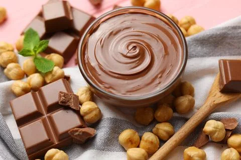 Chocolate paste with a bowl on a table. Stock Photos