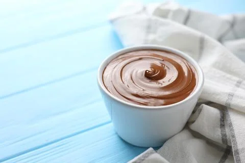 Chocolate paste with a bowl on a table. Stock Photos