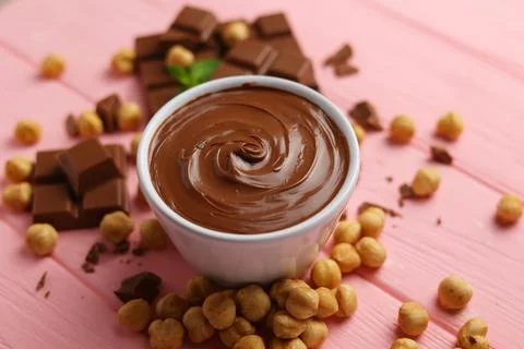 Chocolate paste with a bowl on a table. Stock Photos
