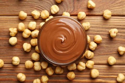 Chocolate paste with a bowl on a table. Stock Photos