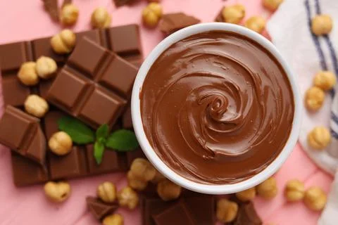 Chocolate paste with a bowl on a table. Stock Photos