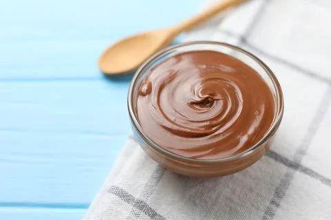 Chocolate paste with a bowl on a table. Stock Photos
