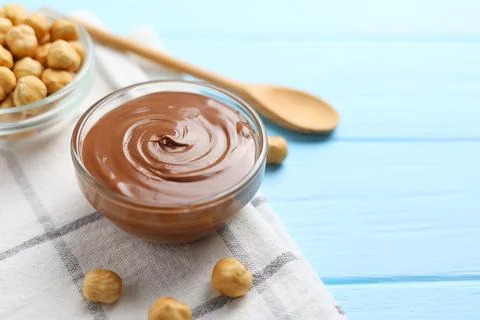 Chocolate paste with a bowl on a table. Stock Photos