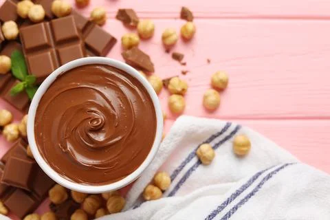 Chocolate paste with a bowl on a table. Stock Photos