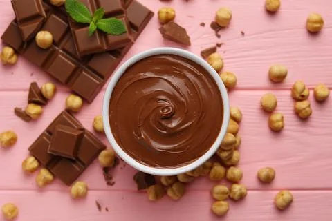 Chocolate paste with a bowl on a table. Stock Photos