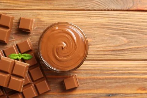 Chocolate paste with a bowl on a table. Stock Photos