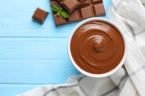 Chocolate paste with a bowl on a table. Stock Photos