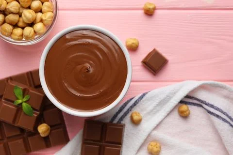 Chocolate paste with a bowl on a table. Stock Photos