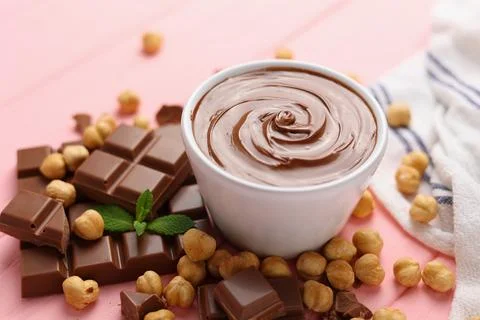 Chocolate paste with a bowl on a table. Stock Photos